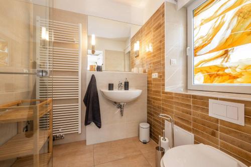 a bathroom with a sink and a toilet in it at Ferienanlage Seeblick Kunstquartier in Koserow