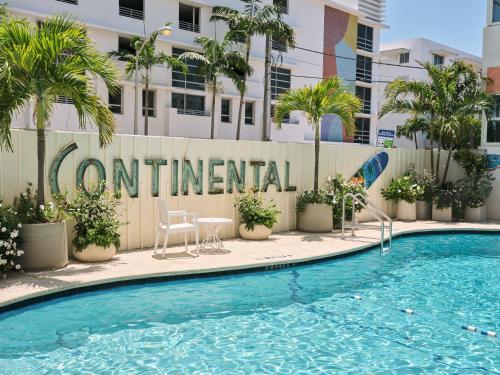 a hotel swimming pool with a sign that readscontinental at Hotel Continental Miami Beach, Tapestry Collection by Hilton in Miami Beach