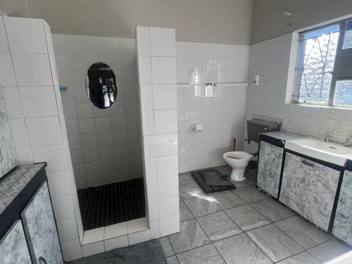 a bathroom with a toilet and a sink at One love suites in Mokopane