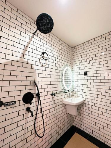 a bathroom with a shower and a sink at The Movia Residences 1 in Enugu