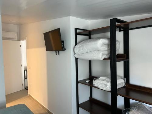 a room with three bunk beds and a television at casa da Inês in Vieira de Leiria