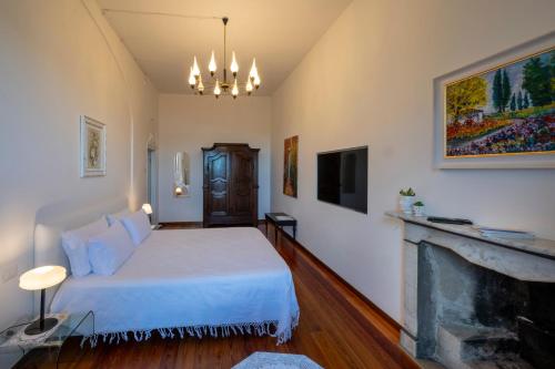 a bedroom with a bed and a fireplace at Il Giardino di Sofia in Arona