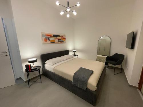 a bedroom with a large bed and a mirror at Moon Apartments B in Soverato Marina