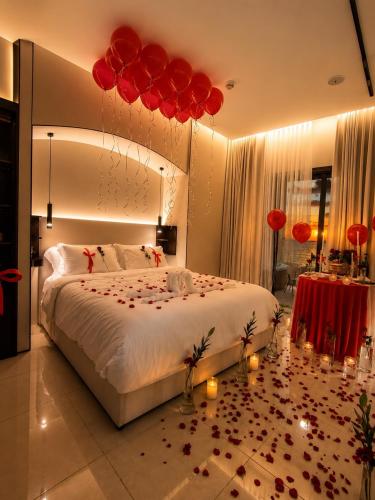 a bedroom with a large bed with red balloons at برج داماك الجوهرة جدة - Damac Al Jawharah Tower in Jeddah