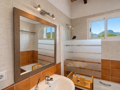 a bathroom with a sink and a mirror and a tub at Finca Tramuntana in Palma de Mallorca