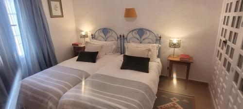 a bedroom with two beds with pillows at Georgesville in Marbella