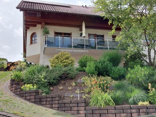 a house with a garden in front of it at Ferienwohnung Himmelsbach in Schuttertal
