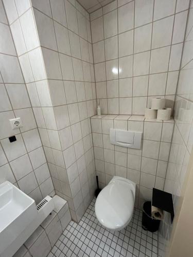 a white bathroom with a toilet and a sink at Gemütliche Wohnung in Passau in Passau