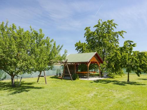 a gazebo in the middle of a field with trees at Apartment Gyula by Interhome in Balatonszemes