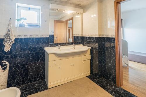 a bathroom with a sink and a mirror at Cantinho do Cávado in Fão