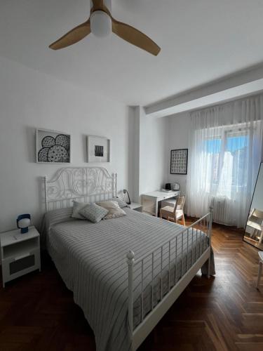 a bedroom with a bed with a ceiling fan at Sunset Suite in Laveno-Mombello
