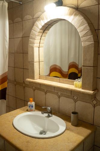 a bathroom with a sink and a mirror at Angela's studios in Elafonisos