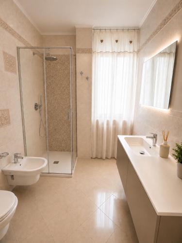 a bathroom with a shower and a sink and a toilet at Residenza Sant'Antonio - Sottomarina in Sottomarina