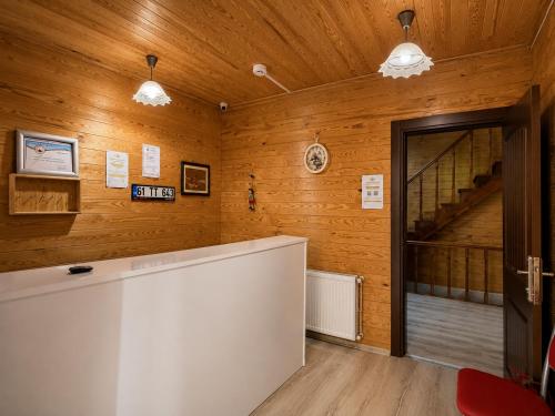 a room with wooden walls with a staircase and a door at CERRAHPAŞA SUİTE HOTEL in Uzungöl