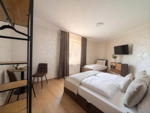 a hotel room with a bed and a bathroom at Zemlinsky Hof in Payerbach