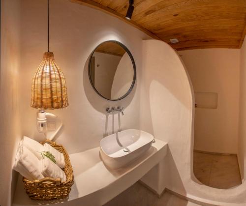 a bathroom with a sink and a mirror at Deluxe Rooms Pet Friendly in Fethiye
