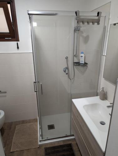a bathroom with a shower and a sink at Koras 142 in Sennori
