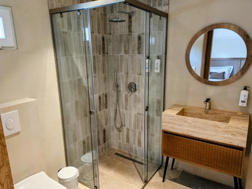 a bathroom with a shower and a sink at AMZA Valbona Mountain Retreat in Valbonë