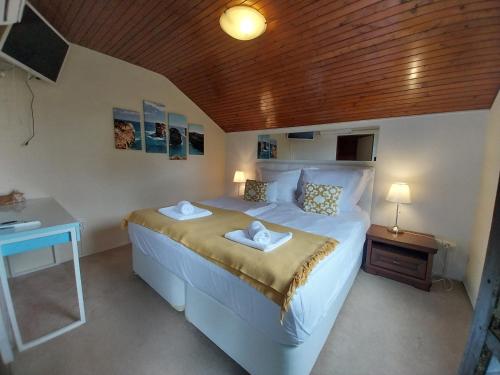 a bedroom with a bed with two towels on it at Buda Weekend House in Budapest