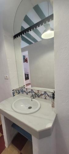 a bathroom with a white sink and a mirror at Georgesville in Marbella
