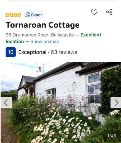 a screenshot of a house with a garden with flowers at Tornaroan Cottage in Ballycastle