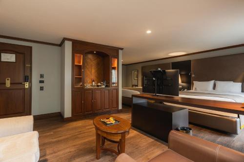 a hotel room with a bed and a couch at Hotel Park10 in Medellín