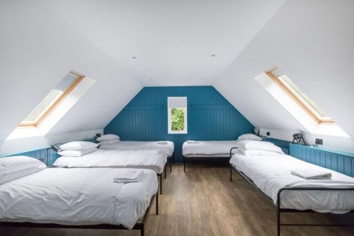 a room with four beds in a attic at Big Lodge in Peebles
