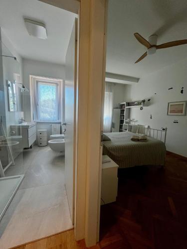 a bedroom with a bed and a bathroom at Sunset Suite in Laveno-Mombello
