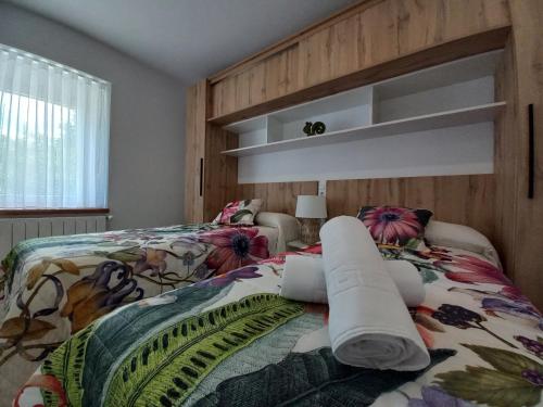 a bedroom with two beds and a large window at La Capital del Mundo in Arredondo