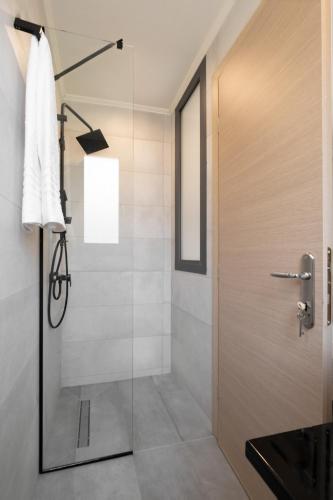 a shower with a glass door in a bathroom at Villa Ilianthi in Kalamitsi
