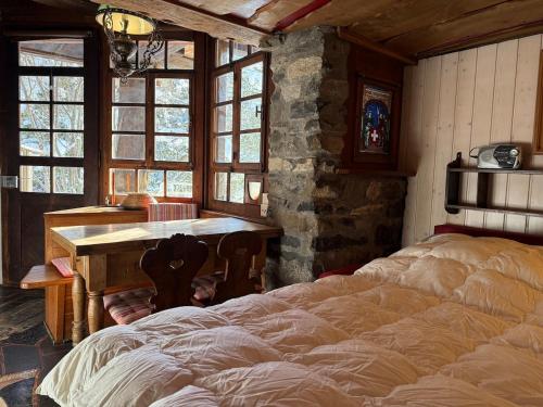 a bedroom with a table and a bed in it at Le Mazot des Révines - 2 pers in Champéry