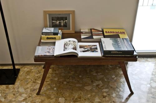 a table with a pile of books on it at Limen Matera Guesthouse in Matera