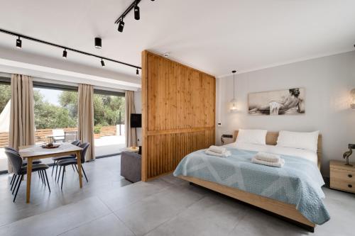 a bedroom with a bed and a desk and a table at Villa Ilianthi in Kalamitsi