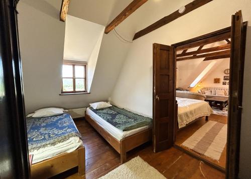 a room with two beds and a door to a bedroom at Casa Cojo in Sighişoara
