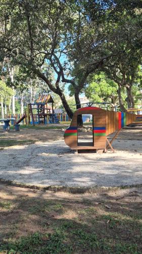 a playground with a tent and a slide in a park at Casa c ar cond, wifi, a 5 min Orla da Lagoa Para Famílias in Araruama