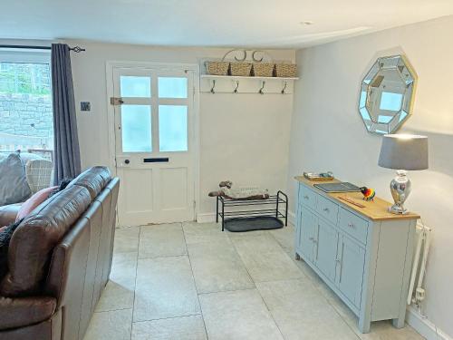a living room with a couch and a table at Cosy Cottage in Portinscale