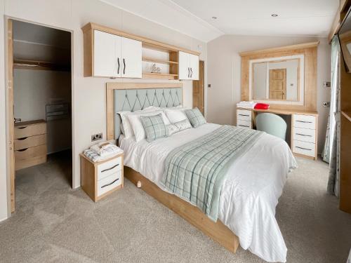 a bedroom with a large bed and a desk at Sandy Shore - Uk37724 in Ingoldmells