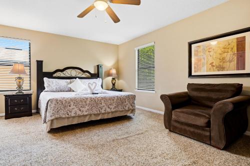 a bedroom with a bed and a chair at Family Friendly - South Facing Pool - Game Room - Gated - Near Disney in Davenport