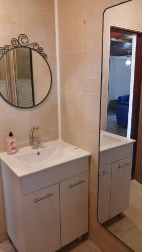 a bathroom with a sink and a mirror at Little Hula in Yesod Hamaala