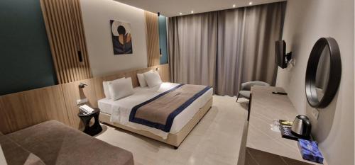 a bedroom with a bed and a tv in a room at Levante Athletic Resort in Afantou