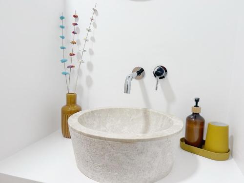 a bathroom with a white sink with a faucet at Casa da Maria in Évora