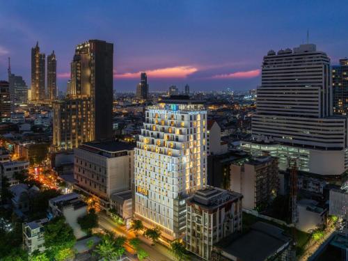 a view of a city skyline at night at Mercure Bangkok Surawong in Bangkok