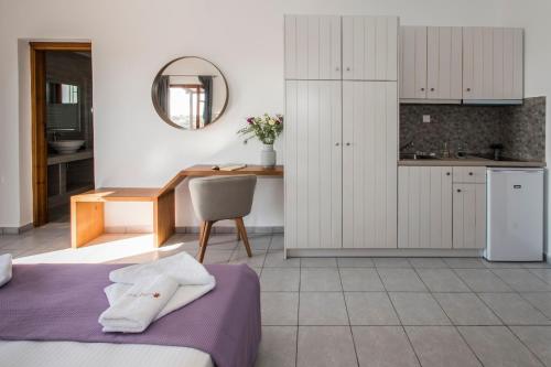 a kitchen and dining room with a bed and a table at Galini in Agia Irini Milos