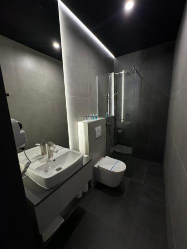 a bathroom with a sink and a toilet at Gravity Resort & Spa in Solotvyno
