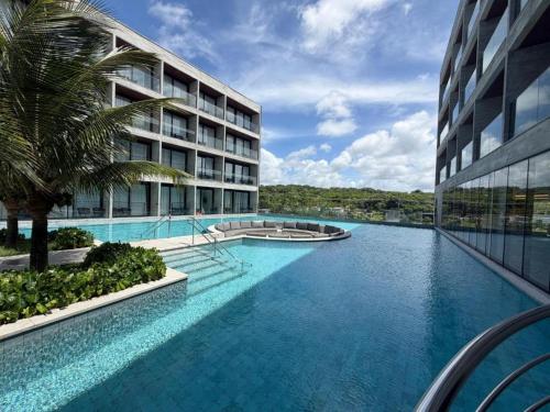 a swimming pool in front of a building at Gav Resorts in Ipojuca