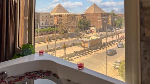 a window with a view of a street and buildings at Hammis Pyramids View INN in Cairo