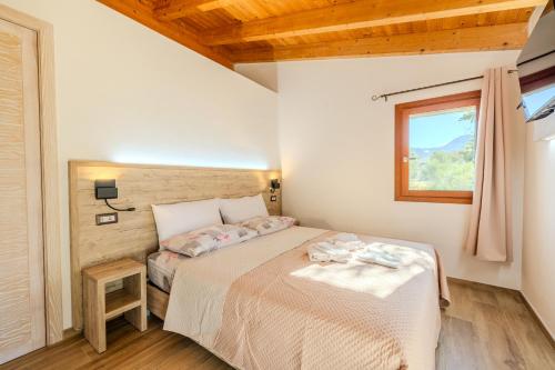 a small bedroom with a bed and a window at S'istella suite in Olbia