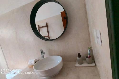 a bathroom with a white sink and a mirror at Precioso chalet en Telchac Puerto in Telchac Puerto