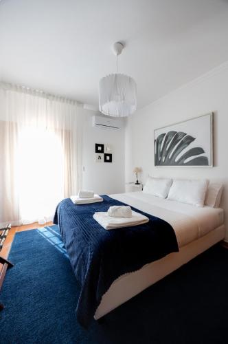 a bedroom with a large bed with two towels on it at Casa da Barragem - Castelo de Bode in Castelo do Bode