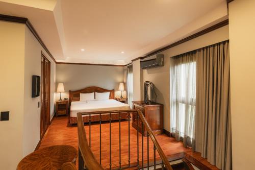 a hotel room with a bed and a balcony at Hotel Park10 in Medellín
